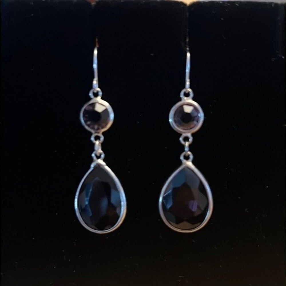 Handcrafted silver tone earrings with a Smokey colored stone.